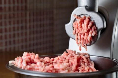 Minced meat coming out from modern electric grinder. Healthy fresh homemade m Foto stock