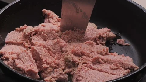 Minced meat is fried in a frying pan in vegetable oil. Medium shot. Stock Footage 304517825