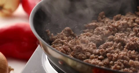 Minced meat is fried in a pan with steam. Stock Footage 249663151