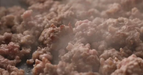 Minced meat is fried in a pan with steam. Stock Footage 249663396