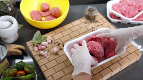 Minced meat mixing process in the kitchen work surface, burger preparing at home Stock Footage 219544051