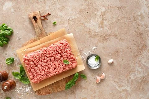 Minced meat raw ground pork and beef on wooden board with ingredients Stock Photos