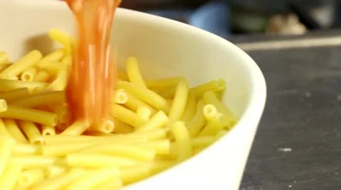 Minced meat sauce being poured over macaroni Stock Footage 24673291