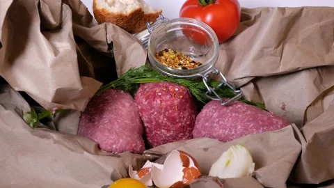 Minced meat on a slate stone black board with fresh herbs. Vidéo 146709734