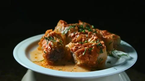 Minced meat stew in cabbage leaves, in the form and on a plate, play with light Stock Footage 153802179