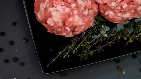 Minced pork. Round balls of minced pork, black pepper on a black dish Stock Footage 144066028