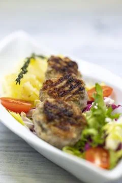 Minced veal steaks with mashed potatoes and salad Stock Photos