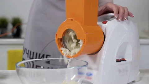 Mincer machine cuts vegetable in kitchen. White electric mincer machines for Vídeo Stock 130246170