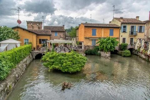 Mincio River and Stone Arch Bridge in Borghetto sul Mincio Stock Photos