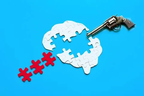 Mind Explosion: Human Brain Puzzle with Pistol on Blue Background Stock Photos