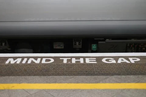 Mind the gap alert. Train station in England. Stock Photos