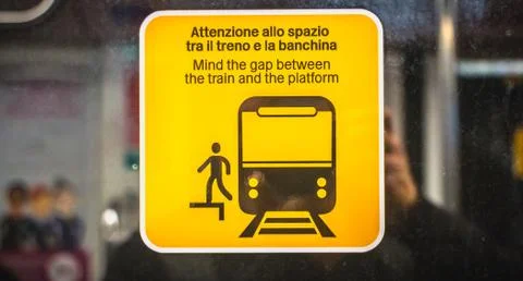 Mind the gap between the train and the platform in Italian and English on Mil Stock Photos