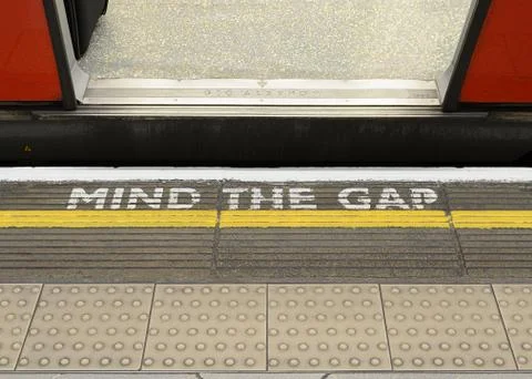 Mind the Gap Warning Sign on the Platform Edge of a London Underground Station Фото