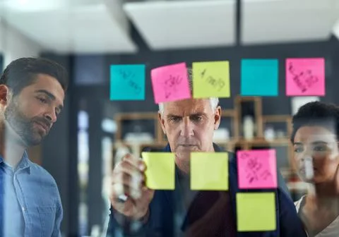 In mind mapping mode. a group of colleagues having a brainstorming session in a Stock Photos