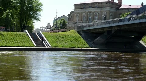 Mindaugas bridge river neris vilnius city people walk Stock Footage 22095476