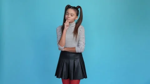 Minded kid touch chin decide thoughts isolated blue color background Stock Footage 166286117