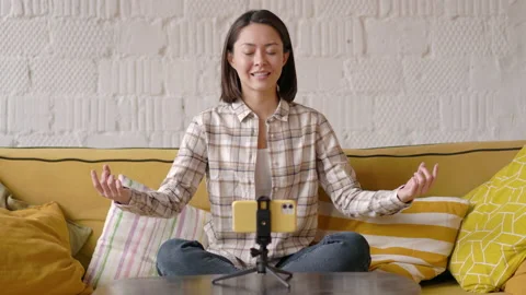 Mindful calm beautiful mixed race female blogger making video lessons and Stock Footage 147321253