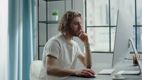 Mindful freelance engineer in white t-shirt works at monitor Stock Footage 152534784