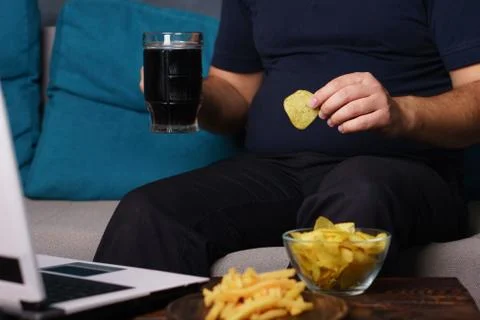 Mindless snacking, overeating, lack of physical activity Stock Photos