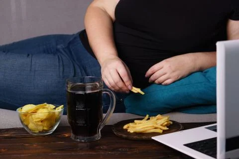 Mindless snacking, overeating, lack of physical activity Stock Photos