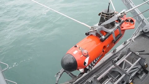 Mine Neutralization Vehicle being lowered into sea from USS Chief Stock Footage 86894044