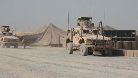 Mine Resistant Ambush Protected vehicles on base in Afghanistan (HD)k Stock Footage 7733699