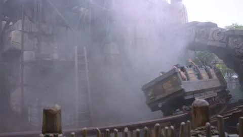 Minecart Aztec Style Rollercoaster, Emerging from Mist in Slow Motion, Pan Shot Stock Footage 342339288