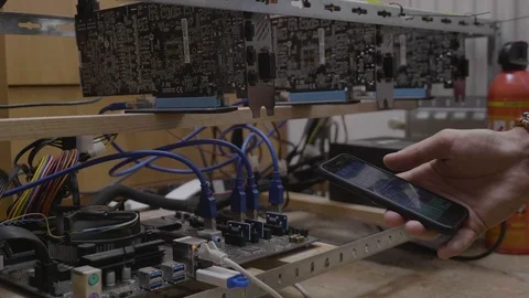 Miner engineer young man watching mining software process on smartphone conne Stock Footage 102472633
