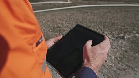 Miner in high-vis using tablet with wireless reception at Australian coal mine 動画素材 333184272