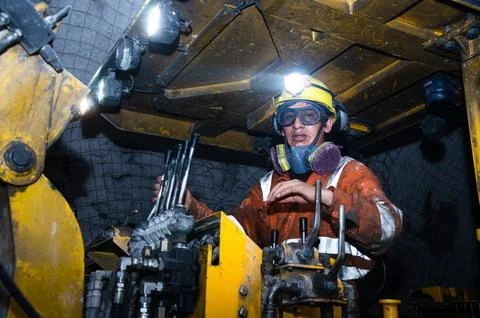 Miner operating a Jumbo Drill in an underground mine. Stock Photos