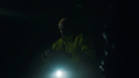Miner puts on a helmet with a flashlight Stock Footage 121179781
