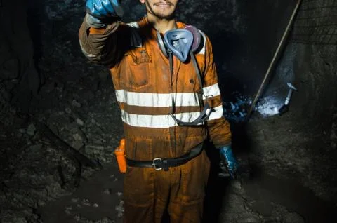 Miner smiling inside the mine Stock Photos