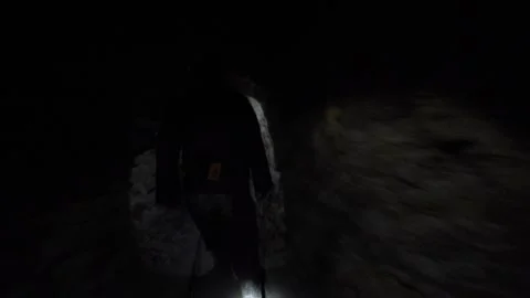 Miner walking inside dark underground tunnel 動画素材 337408601