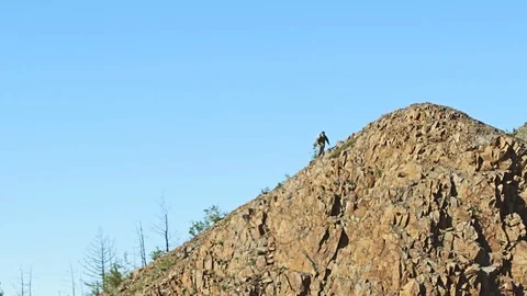 A miner is walking on the top of a mountain Stock Footage 72641501