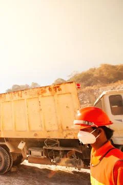 Miner working with mining tool in dusty and baking hot. Stock Photos