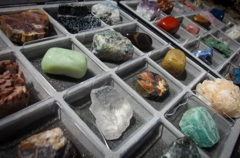 Mineral collection of assorted rocks, crystals and semi precious stones in a box Stock Photos