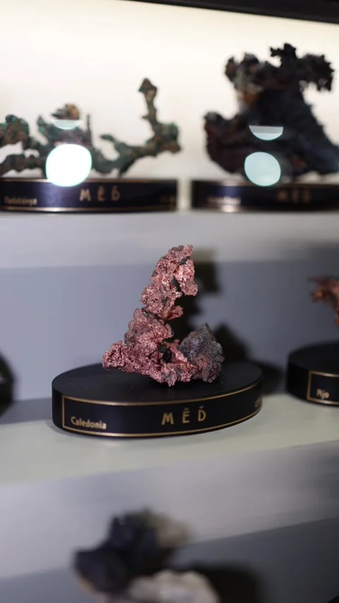 A mineral specimen labeled as "měď" (copper) from Caledonia, displayed on a stan Stock Footage 289637439