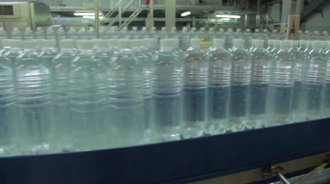 Mineral water  in the factory. Plastic bottles are moved on a conveyor on plant. Stock Footage