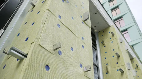Mineral wool fixed to wall during facade insulation process Stock Footage 330198545