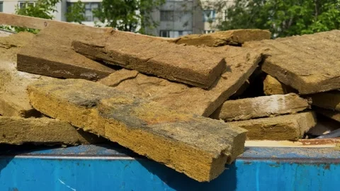 Mineral wool slabs stacked in a construction waste container Stock Footage 336549276