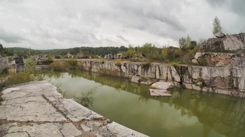 Minerals. People are walking through an old marble quarry next to a pond. Stock Footage 322118693