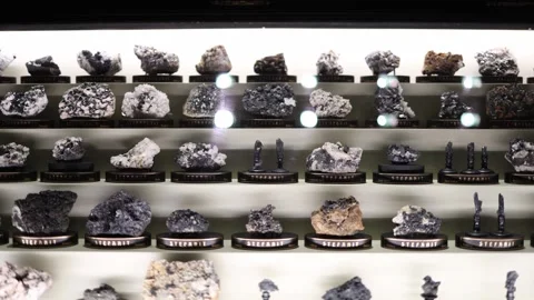 Minerals tetrahedrite and stephanite displayed in illuminated laboratory showcas Stock Footage 320451346
