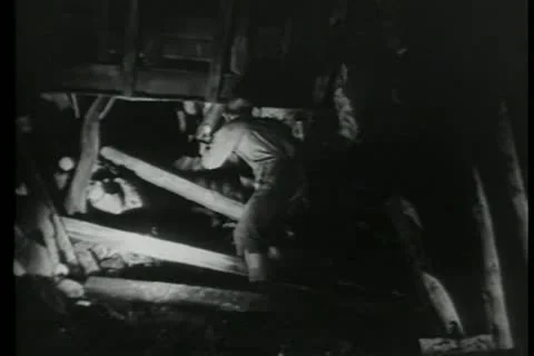 Miners with flashlights checking damage in tunnel Vídeos de archivo 11352611