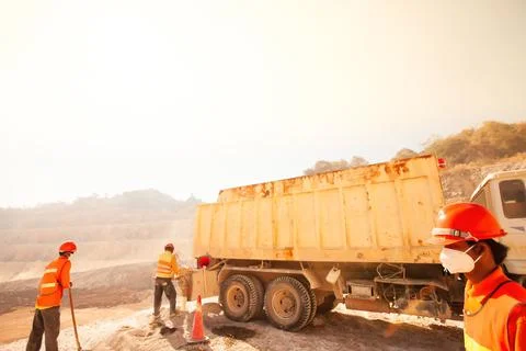 Miners working with mining tool in dusty and baking hot. Stock Photos