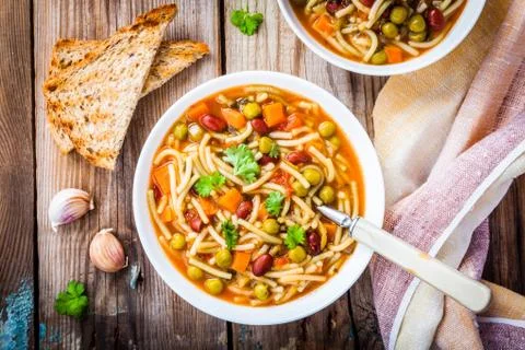 Minestrone soup with whole grain toasts Stock Photos