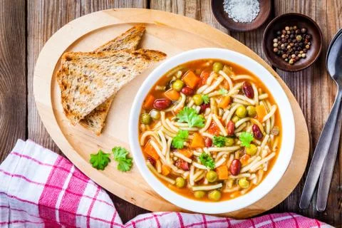 Minestrone soup with whole grain toasts Stock Photos