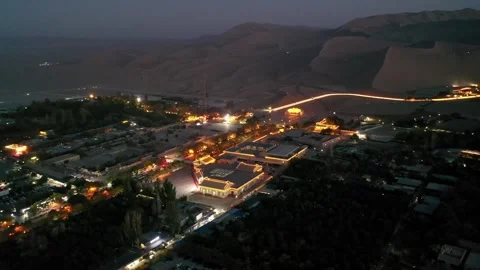 Mingsha Mountain and Crescent Spring at dusk, ​Dunhuang city, Stock Footage 324929621
