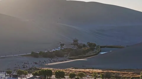 Mingsha Mountain and Crescent Spring at dusk, ​Dunhuang city Stock Footage 324933447