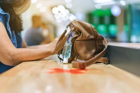 Mini alcohol gel bottle to kill Corona Virus(Covid-19) hang on a leather shou Stock Photos