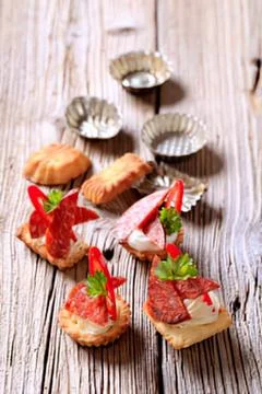 Mini appetizers with tomato and basil on rustic wood Stock Photos
